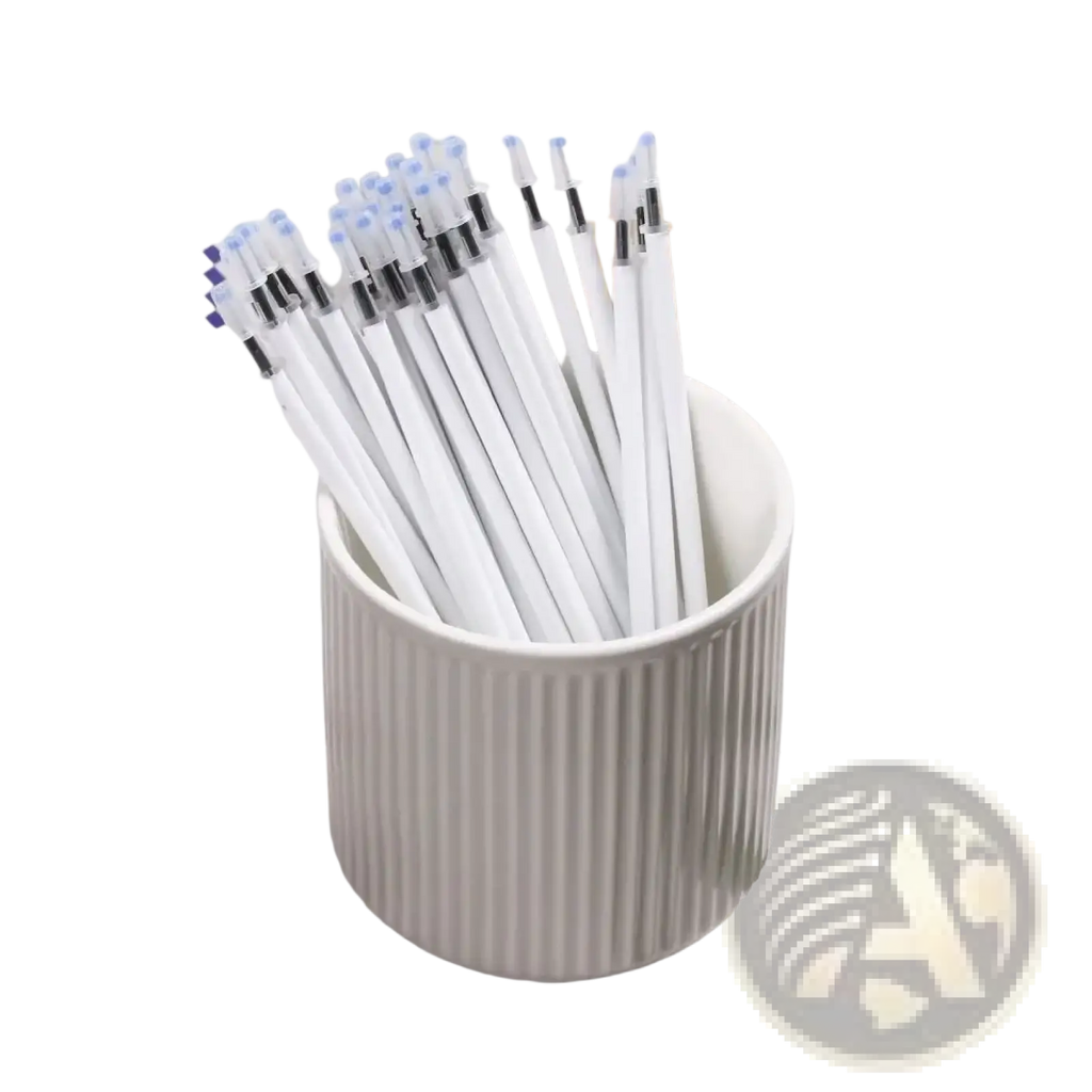 A white ceramic cup with vertical ridges holds a 10 pack of white gel pen refills with black ink and blue and black caps