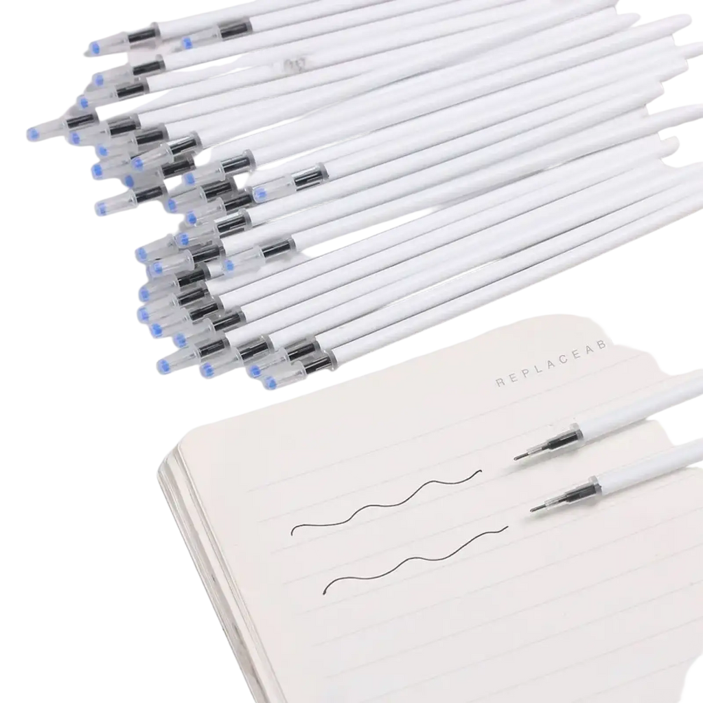 White retractable gel pens with transparent barrels and blue tips arranged on a lined notebook for black ink refills 10 pack