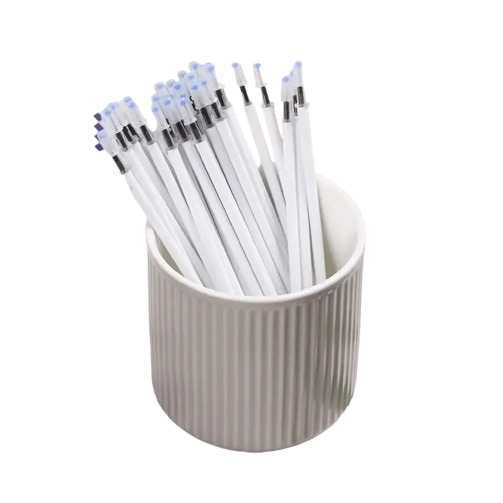 A white ceramic cup with vertical ridges holds a 10 pack of white gel pen refills with black ink and blue and black caps