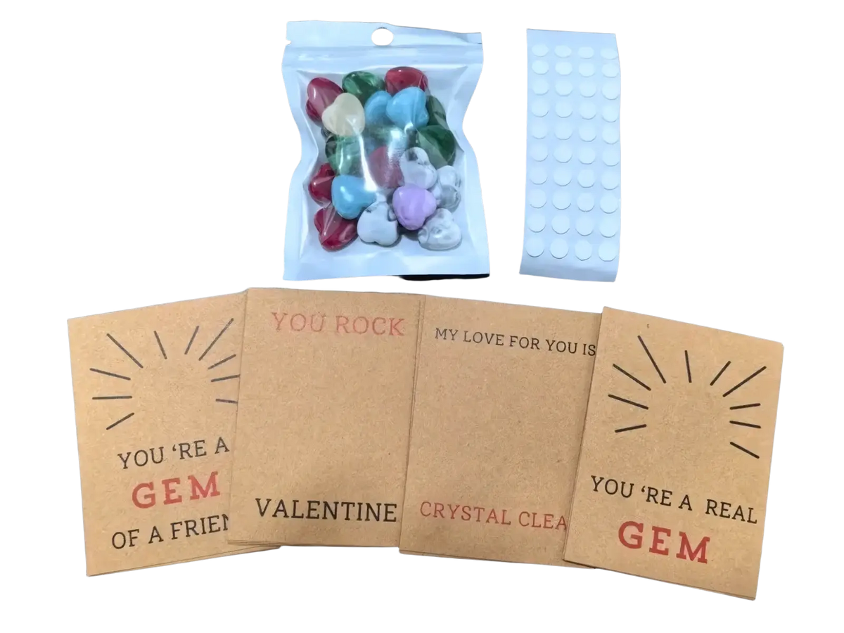 A clear plastic bag filled with colorful heart-shaped candy gems in red blue green and purple for gemstone heart valentine cards 24 pack