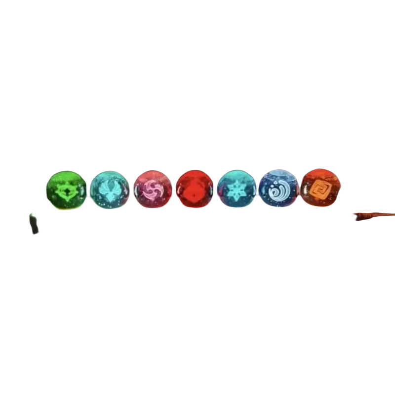 Seven glowing translucent glass orbs with intricate etched designs in various colors on a lit base finished goods