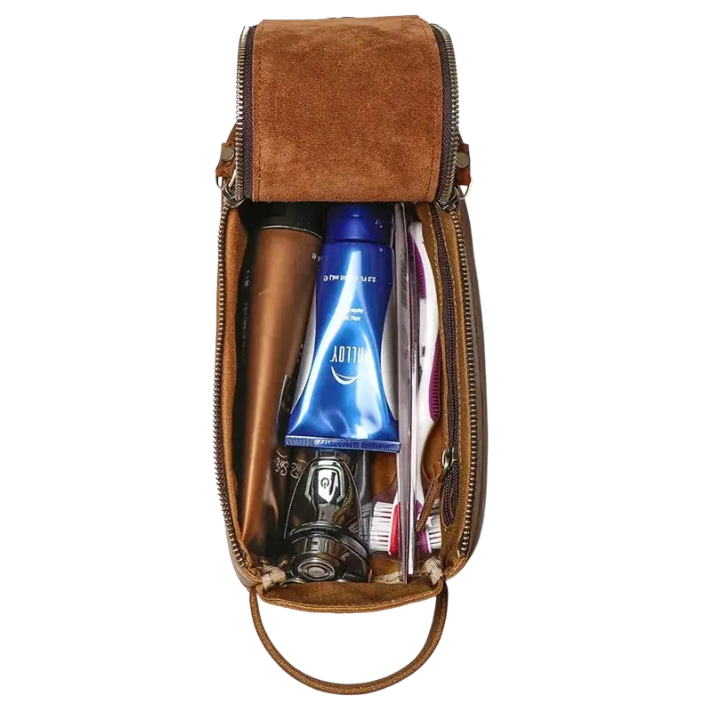 Brown genuine leather clutch bag size 26x15x11cm with zipper closure handle and pocket interior containing grooming items