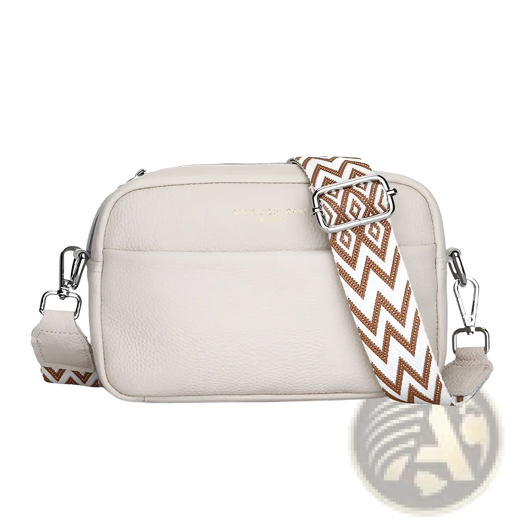 Cream-colored genuine leather crossbody bag with a brown and white zigzag geometric pattern strap