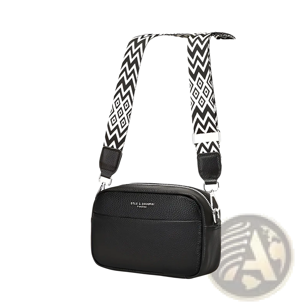 Genuine leather black crossbody bag with textured finish and bold black and white geometric patterned strap