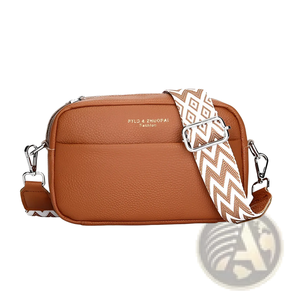 Genuine leather crossbody bag in tan pebbled leather with a white and brown zigzag geometric pattern strap