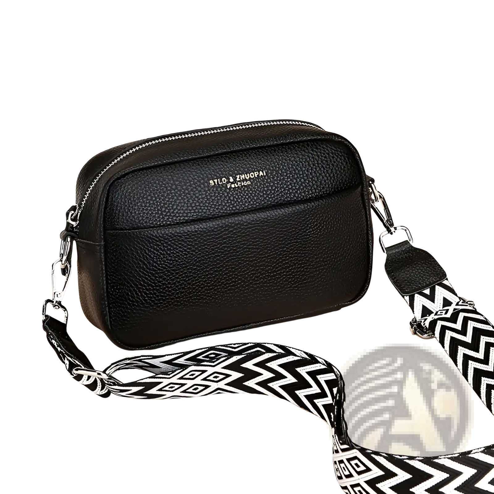 Genuine leather black crossbody bag with textured finish and bold black and white geometric pattern strap