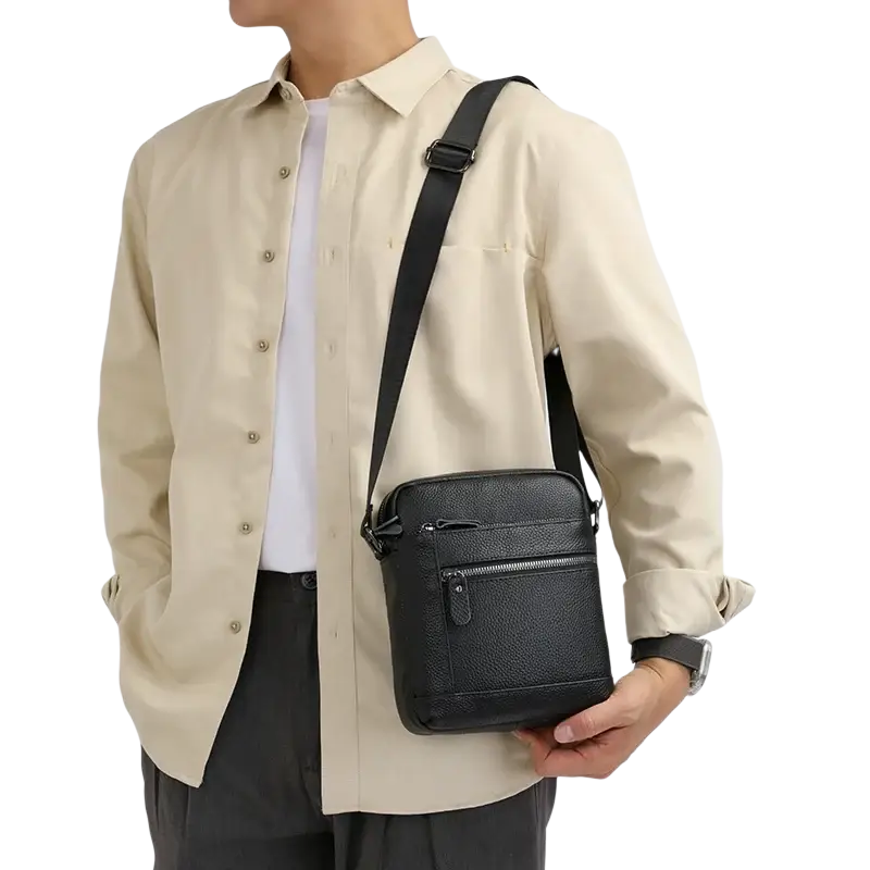 Genuine leather black crossbody bag for men with textured finish sleek minimalist design and multiple zippered compartments