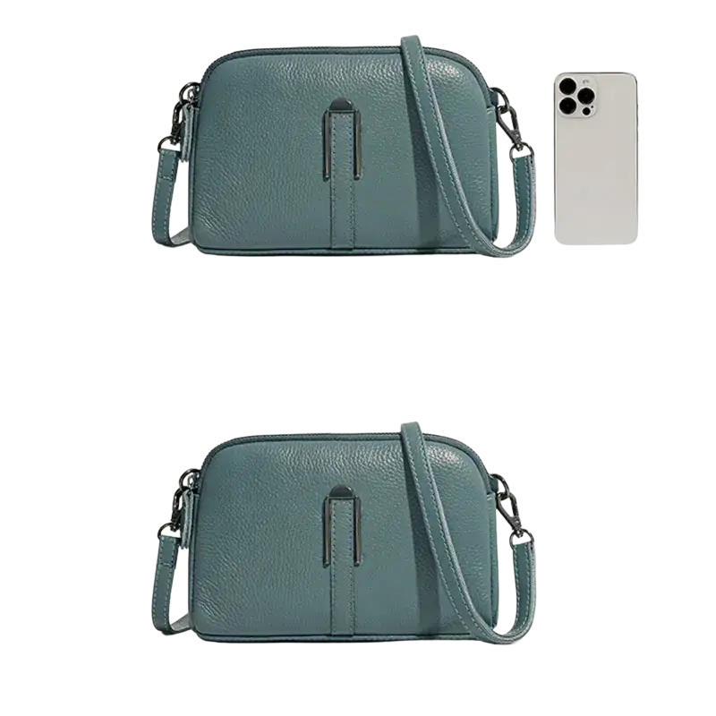 A sleek teal genuine leather crossbody bag for women with a minimalist front flap closure and adjustable strap