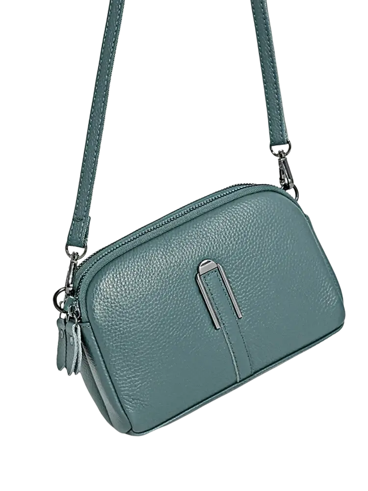 Teal genuine leather crossbody bag for women with pebbled texture, silver-toned clasp, and matching strap