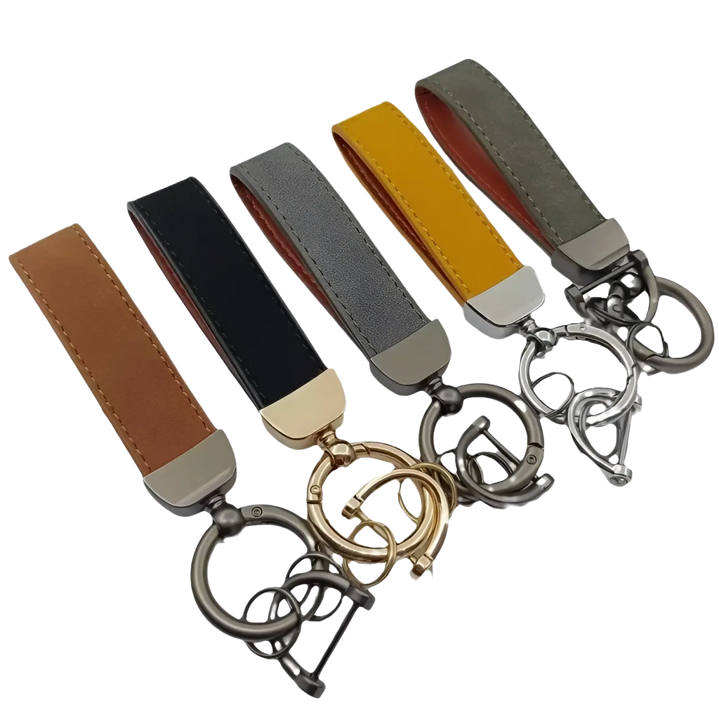 A set of five genuine leather keychains in brown black gray mustard yellow and olive green with metallic hardware