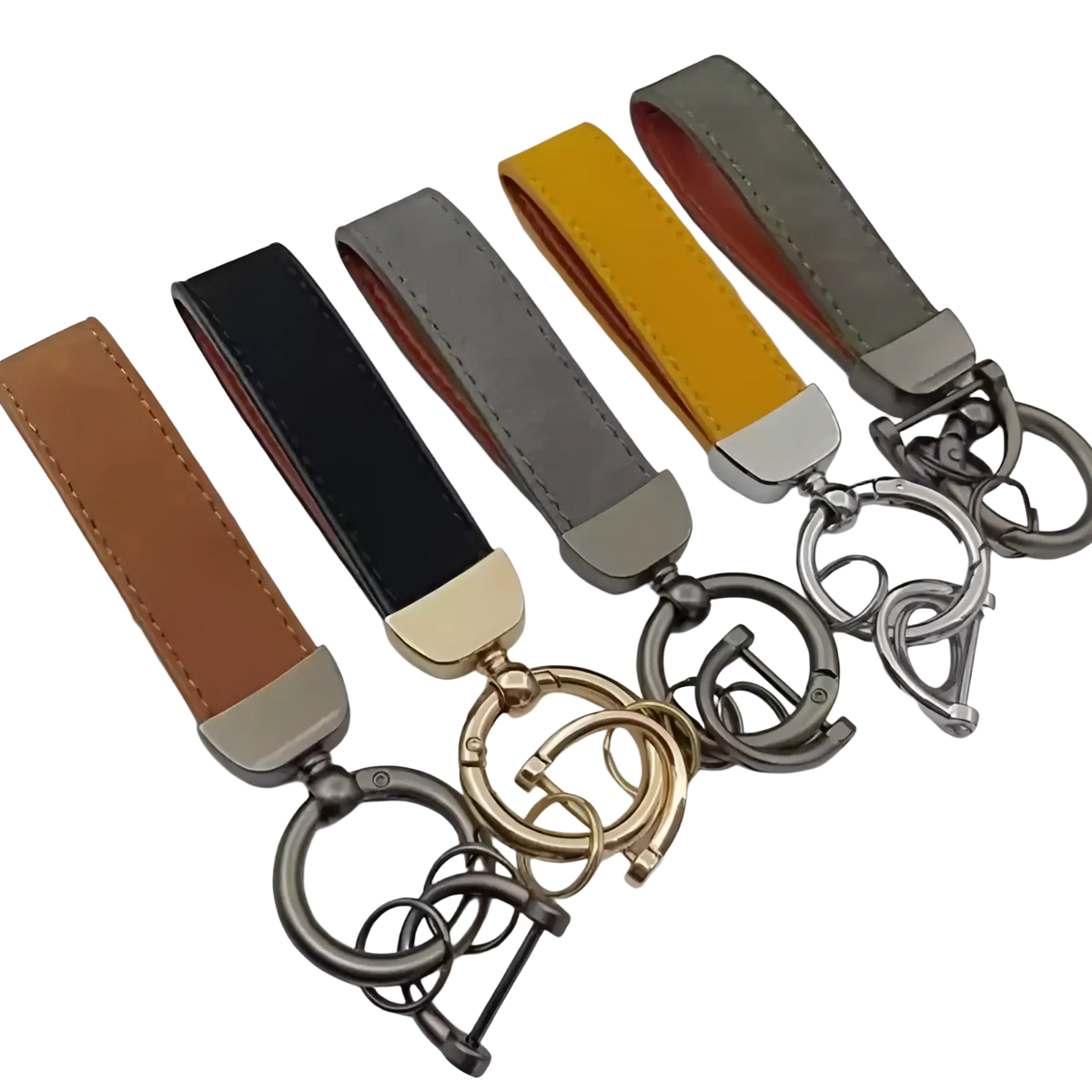 A set of five genuine leather keychains in tan black gray yellow and olive green with metallic hardware for car keys