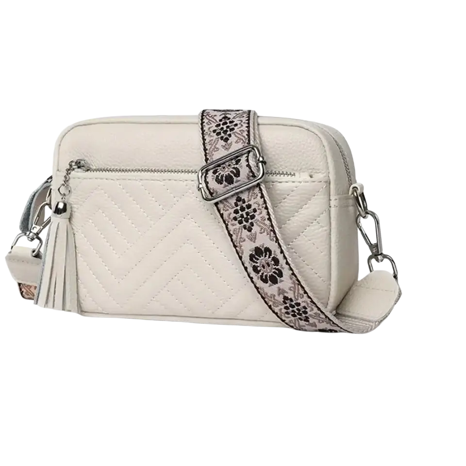 Cream-colored genuine leather quilted crossbody bag with floral-patterned strap and silver-toned hardware