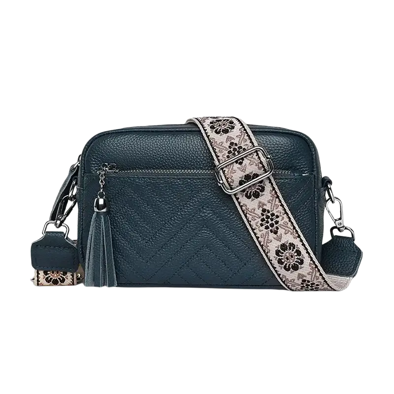 Dark teal genuine leather quilted crossbody bag with floral-patterned strap and tassel detail for leather handbags use