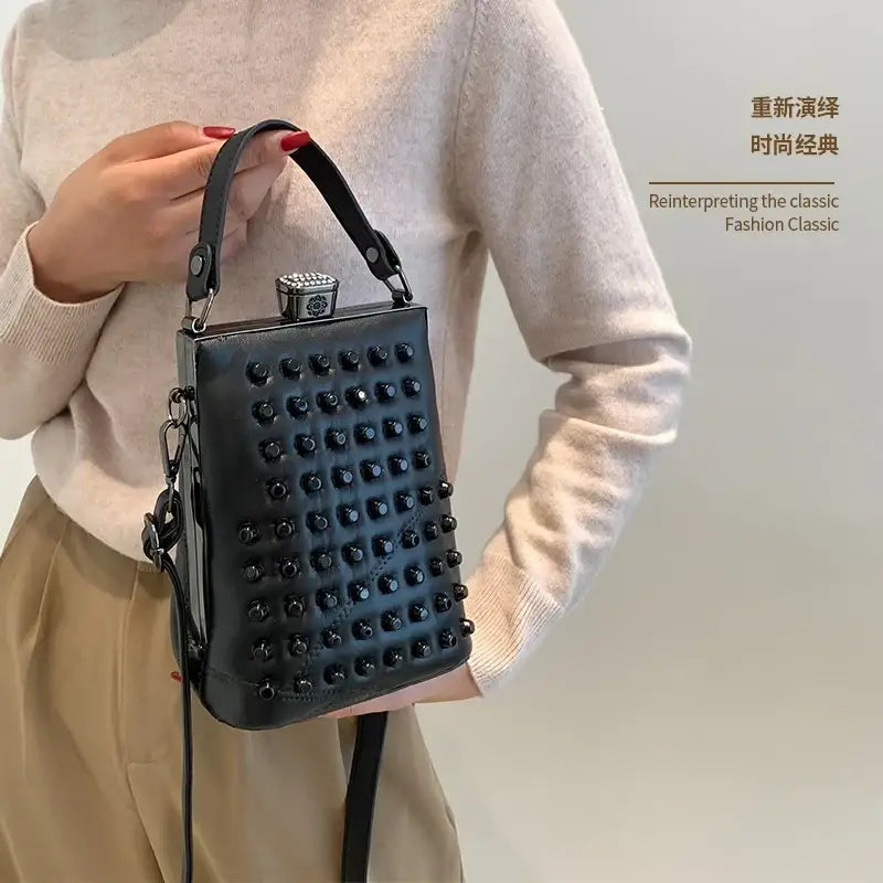 Black studded genuine leather shoulder bag with rectangular frame metallic clasp and phone pocket for convenience