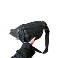 Black genuine leather waist bag with multiple zippers and adjustable strap for versatile crossbody use
