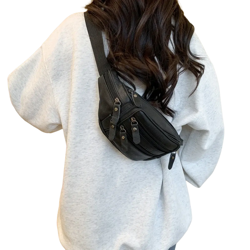 Black genuine leather waist bag with textured finish multiple zippers and metal hardware for versatile use