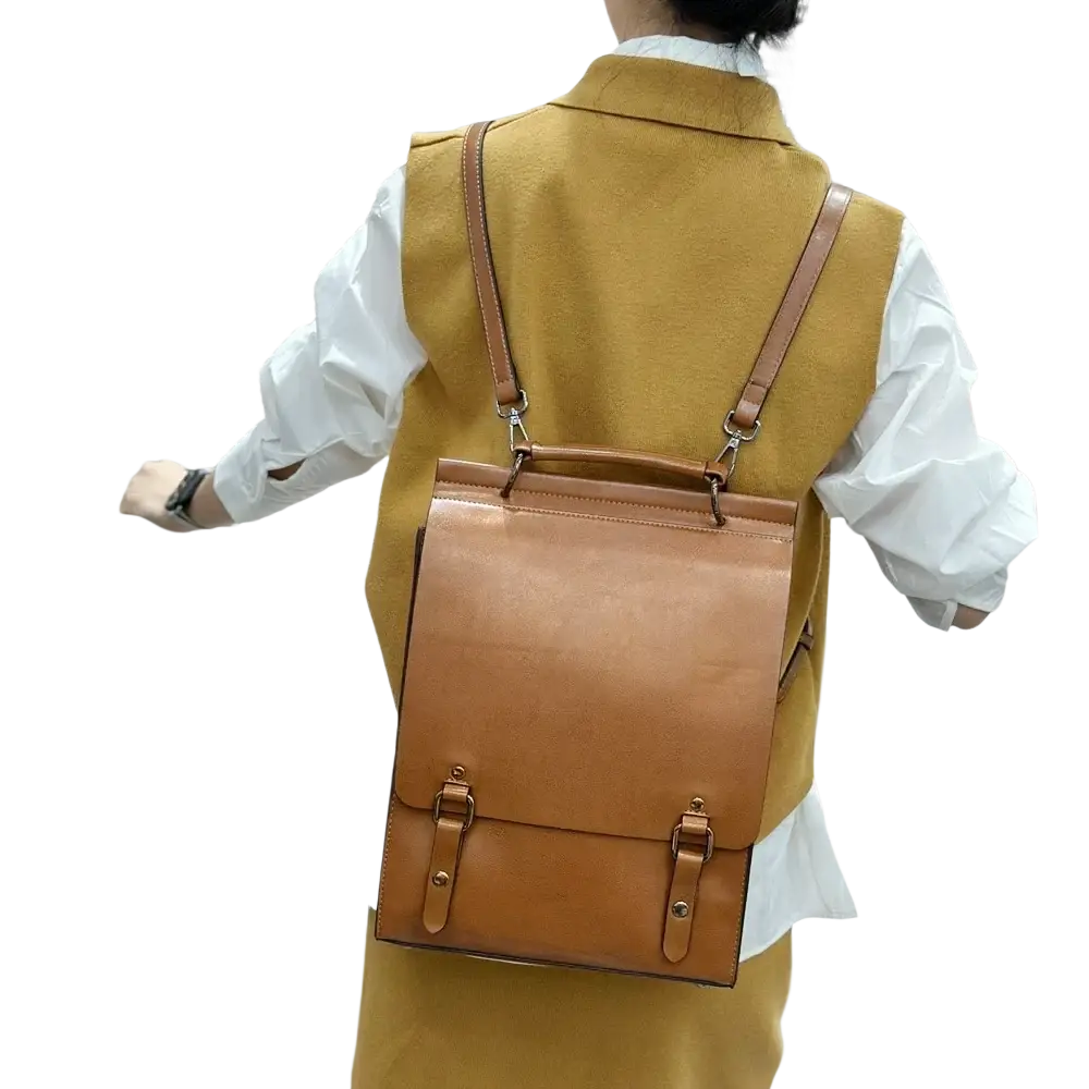 Tan genuine leather women backpack with dual straps and front flap closure for use as a bag book daypack