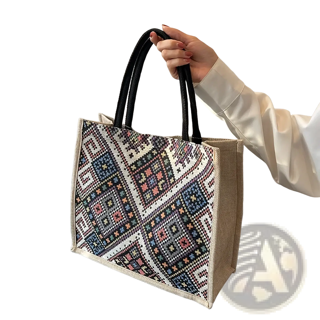 A beige jute geometric canvas tote bag with black handles and colorful floral motifs for casual commuting