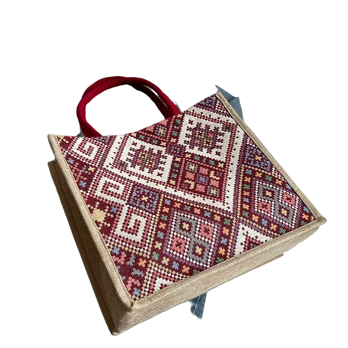 A woven geometric canvas tote bag in maroon white and pastel tones with red fabric handles for casual commuting