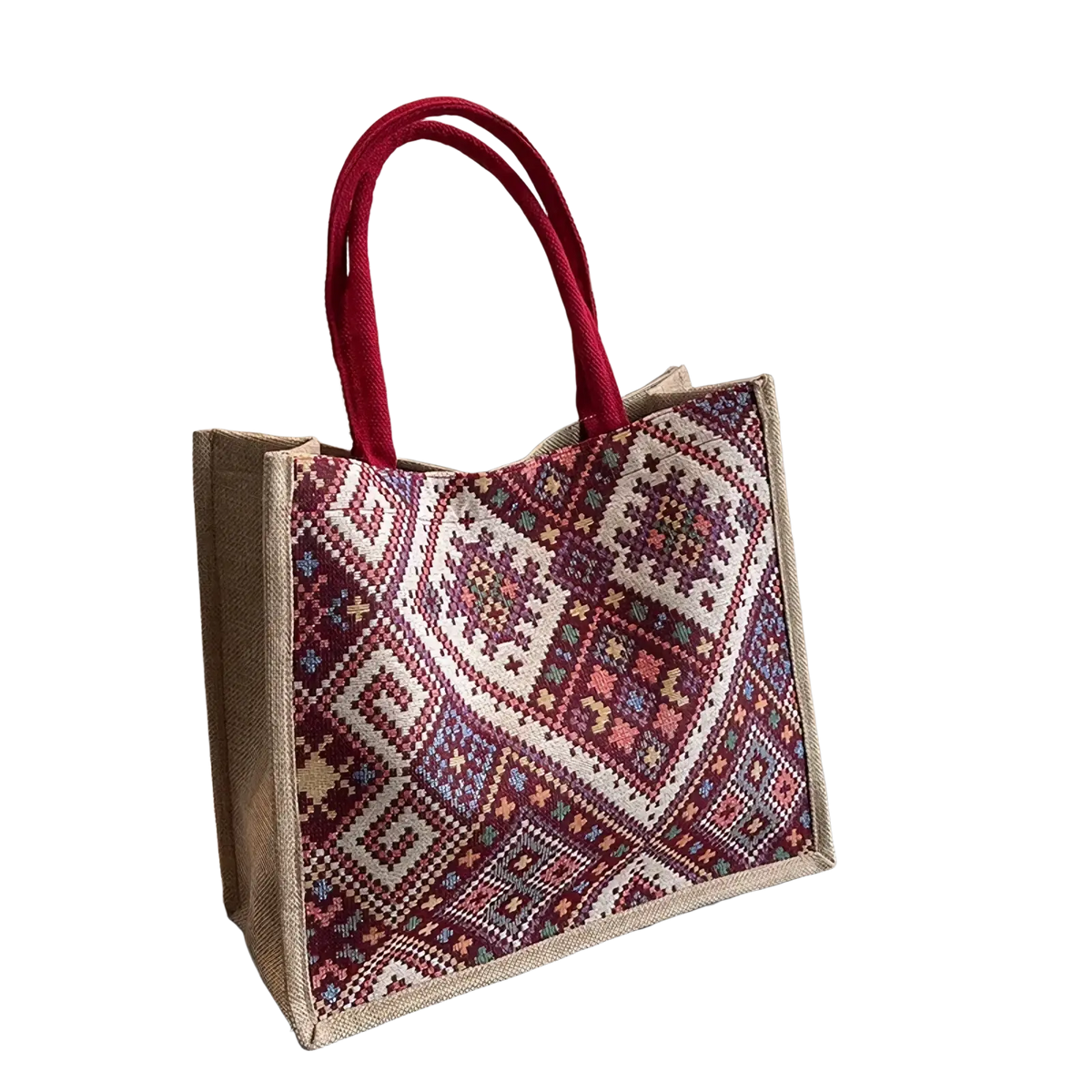 A large woven canvas tote bag with red handles and a vibrant maroon cream pink and blue geometric pattern