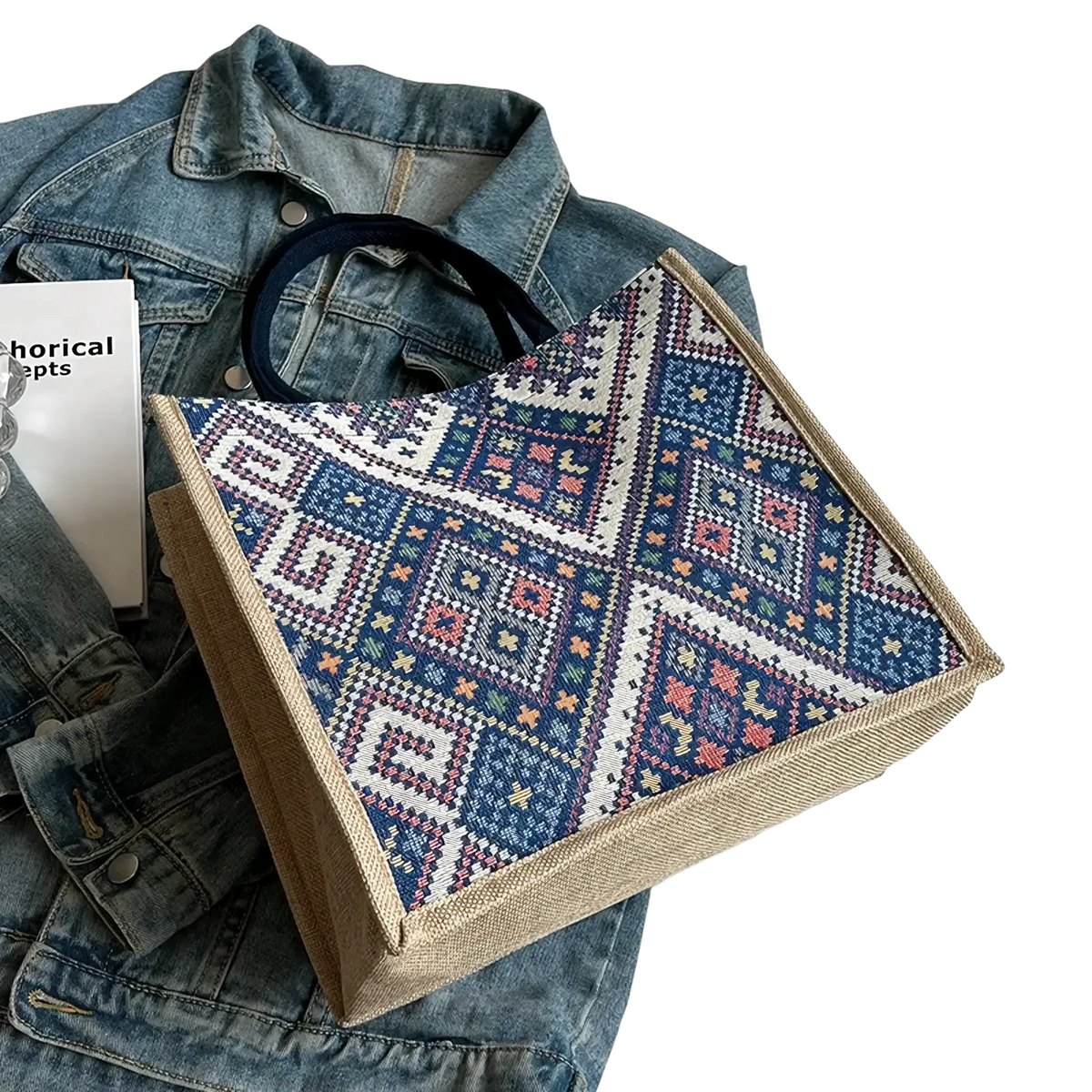A woven geometric canvas tote bag in navy blue white pink and green with sturdy beige fabric edges for casual use