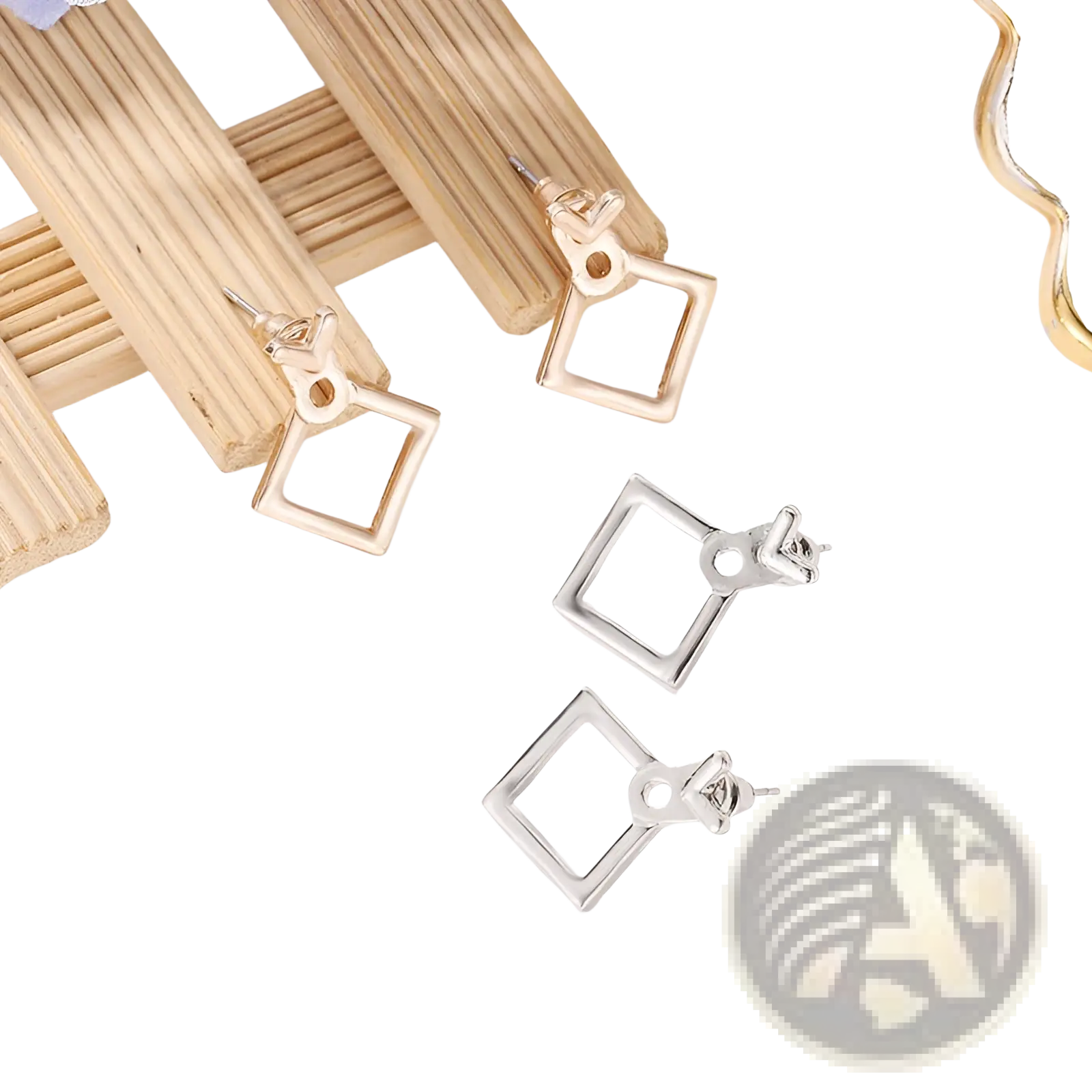 A pair of geometric gold arrow and hollow square stud earrings in gold and silver tones with a sleek metallic finish