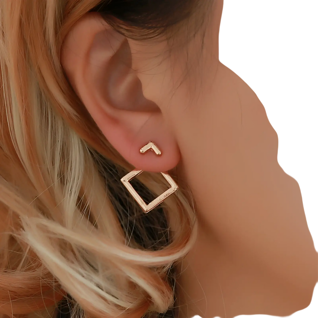 Gold-toned geometric stud earrings featuring a small arrow and a larger hollow square design in gold material