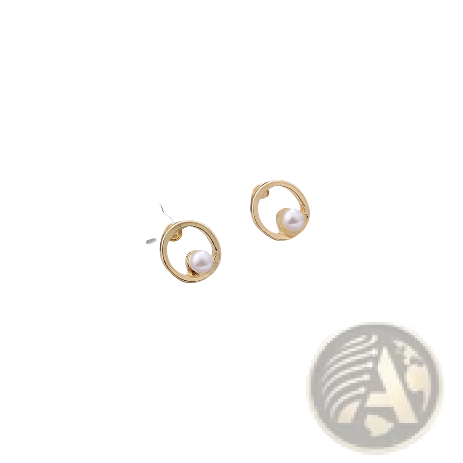 Delicate gold hoop earrings with a single round white pearl nestled within the open circle for elegant wear