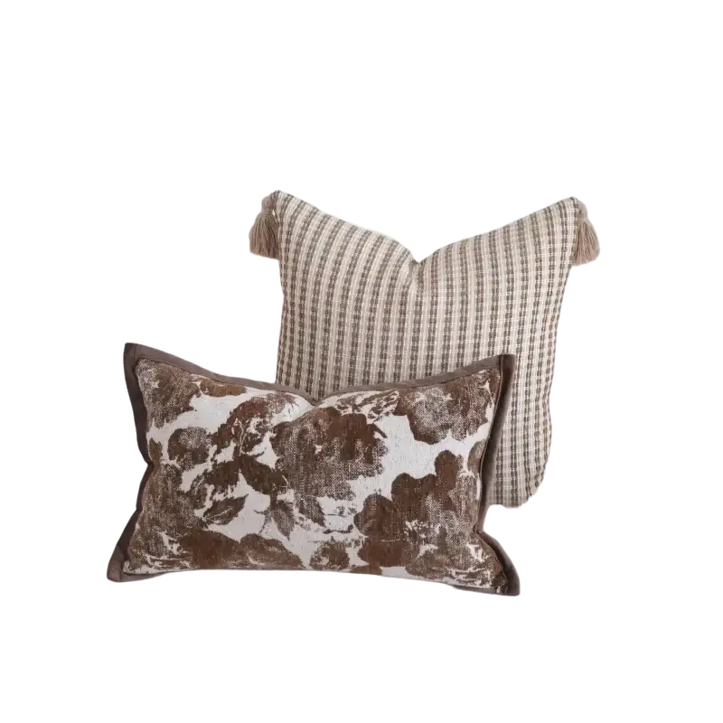 Brown maillard geometric jacquard cushion cover featuring a brown and white floral pattern with tassel trim