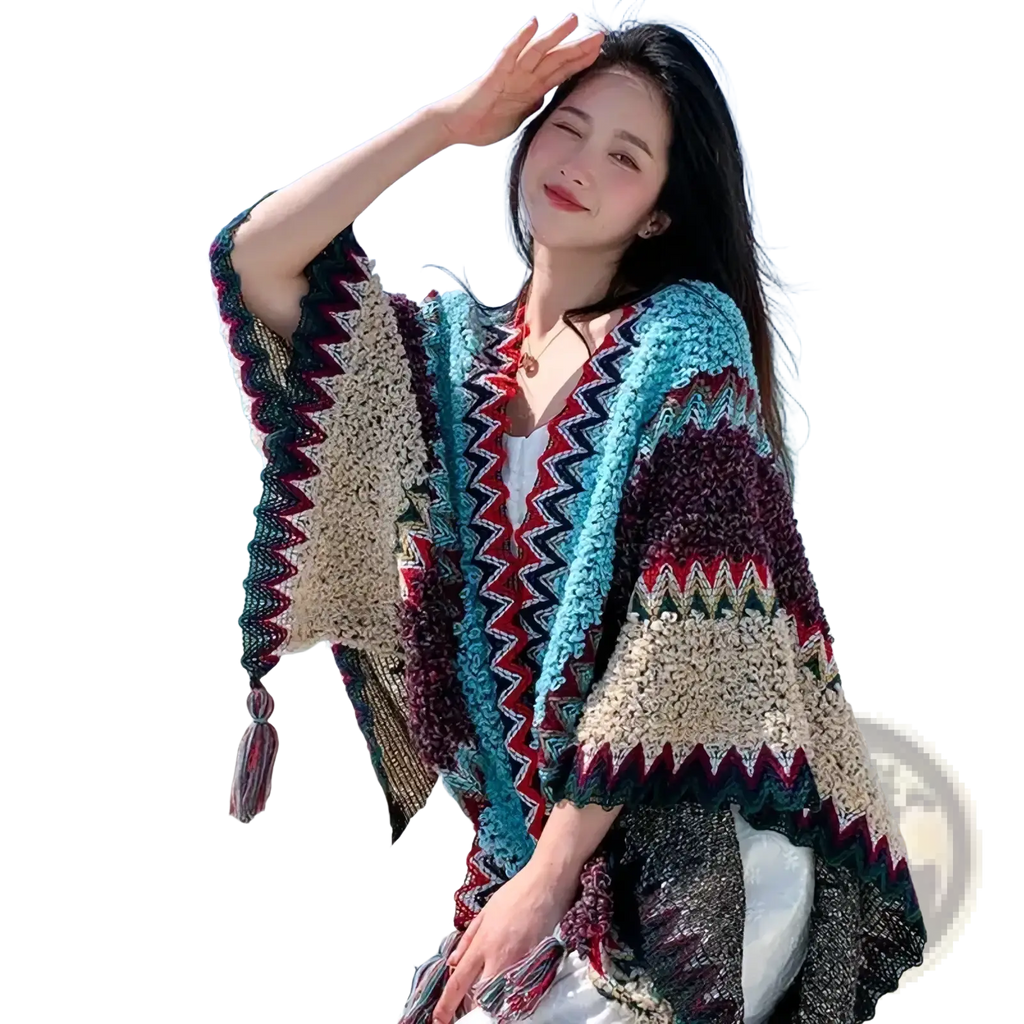 A colorful chunky-knit open-front geometric knit poncho cardigan with zigzag pattern in teal maroon and cream hues