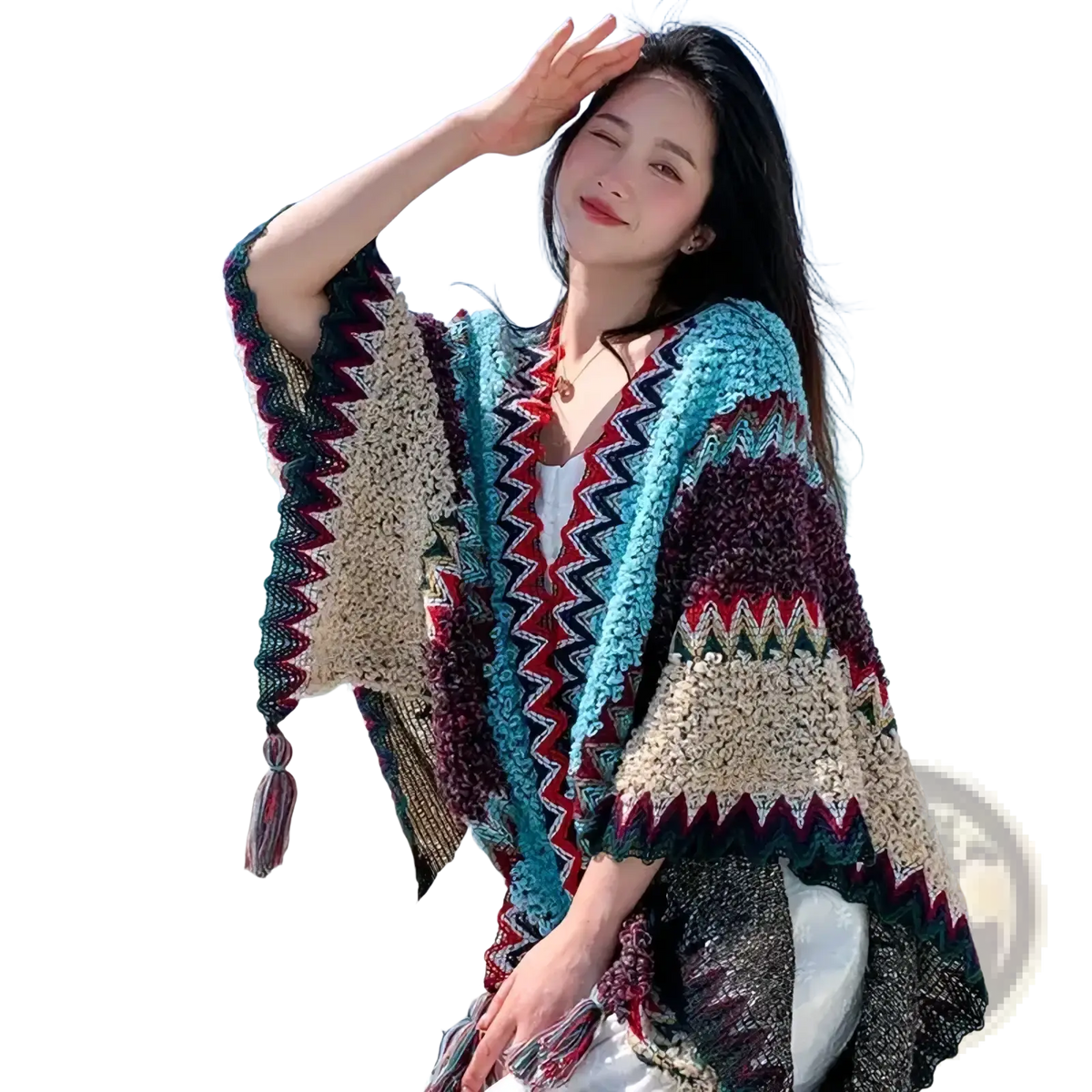A colorful chunky-knit open-front geometric knit poncho cardigan with zigzag pattern in teal maroon and cream hues