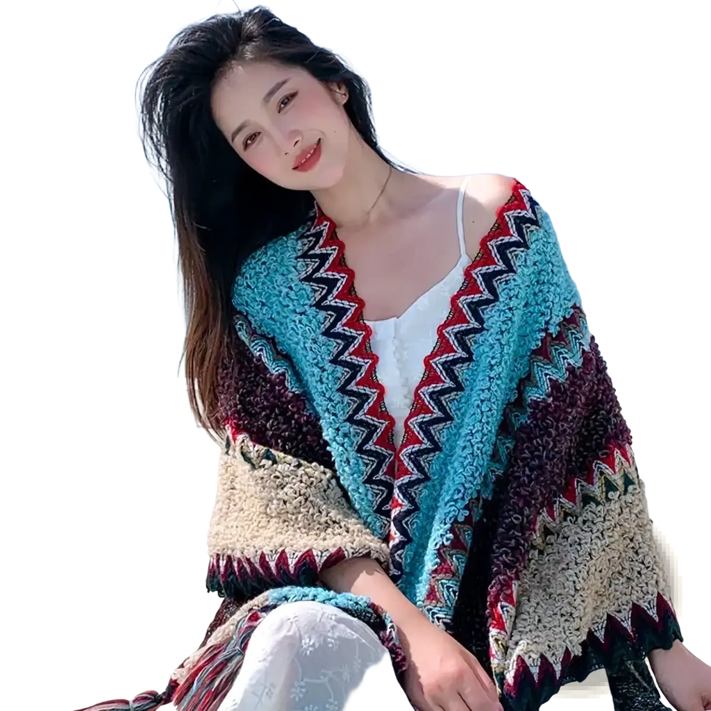 Geometric knit poncho cardigan featuring a chunky-knit zigzag pattern in teal maroon and cream colors