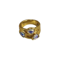 Gold-toned geometric open ring with three iridescent blue and white triangular stones on textured band