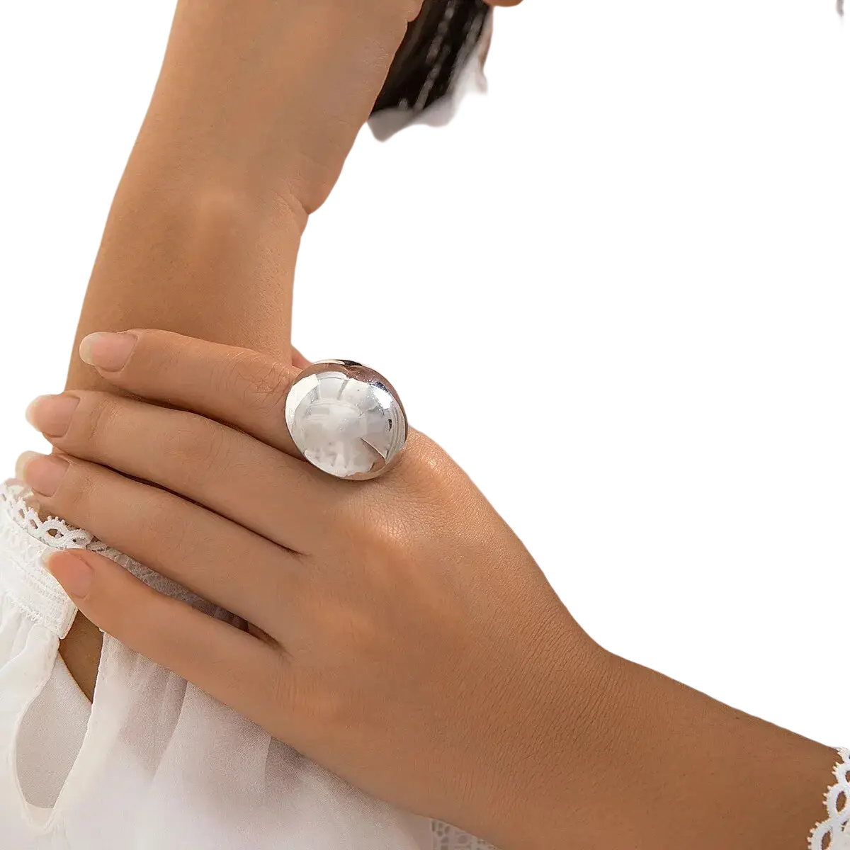 A sleek oversized silver geometric oval open ring for women with a polished reflective circular face