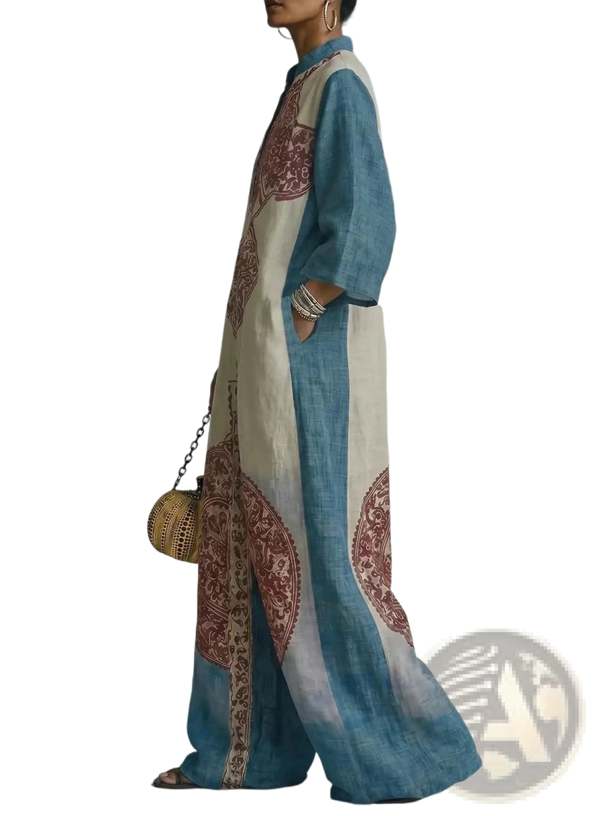A flowing long-sleeved maxi dress in soft blue and cream with maroon paisley patterns along the sides