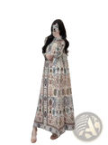 A flowing long-sleeved chiffon abaya maxi dress in soft beige with intricate geometric and floral pleated patterns