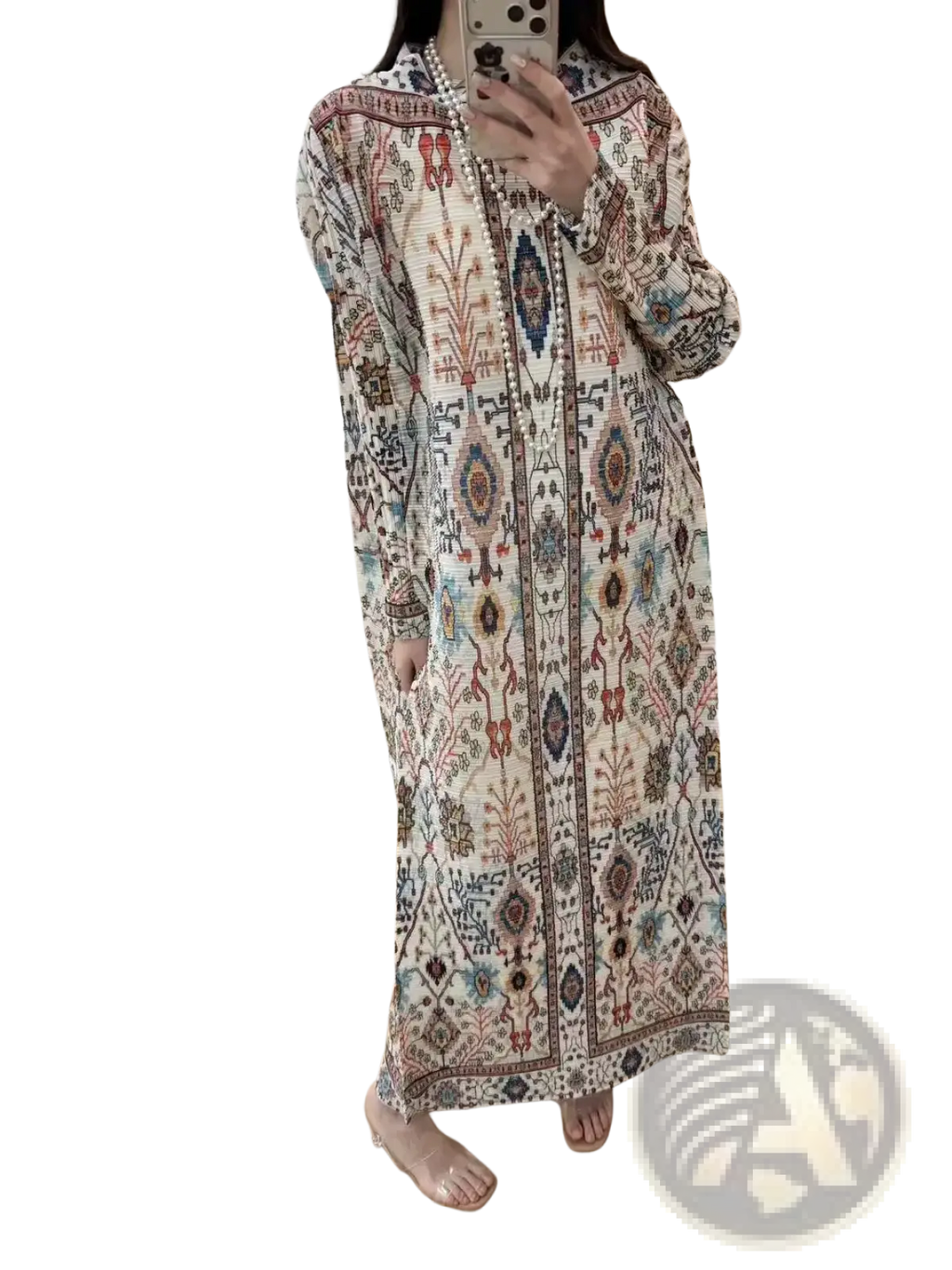 Cream-colored geometric print pleated chiffon abaya maxi dress with flowing fabric and earthy terracotta teal and burgundy patterns