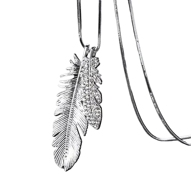Silver feather pendant necklace with intricate detailing and sparkling rhinestones in a geometric statement design for women