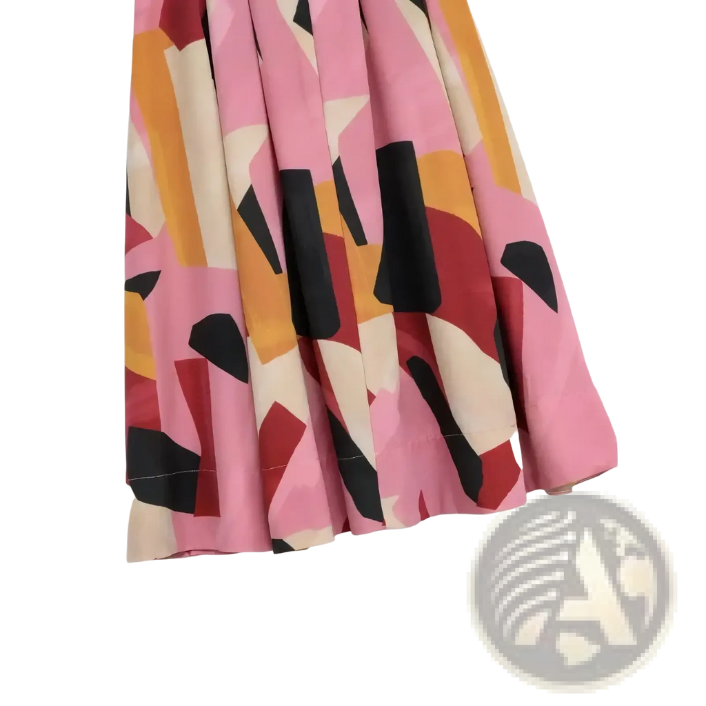 A geometric satin midi skirt with a flared cut in vibrant pink orange black and beige abstract pattern