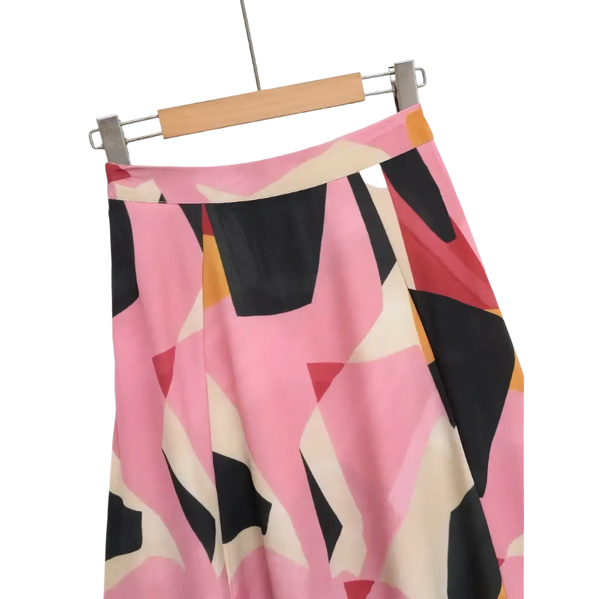 Geometric satin midi skirt in pink black and cream with an abstract geometric print hanging on a wooden hanger