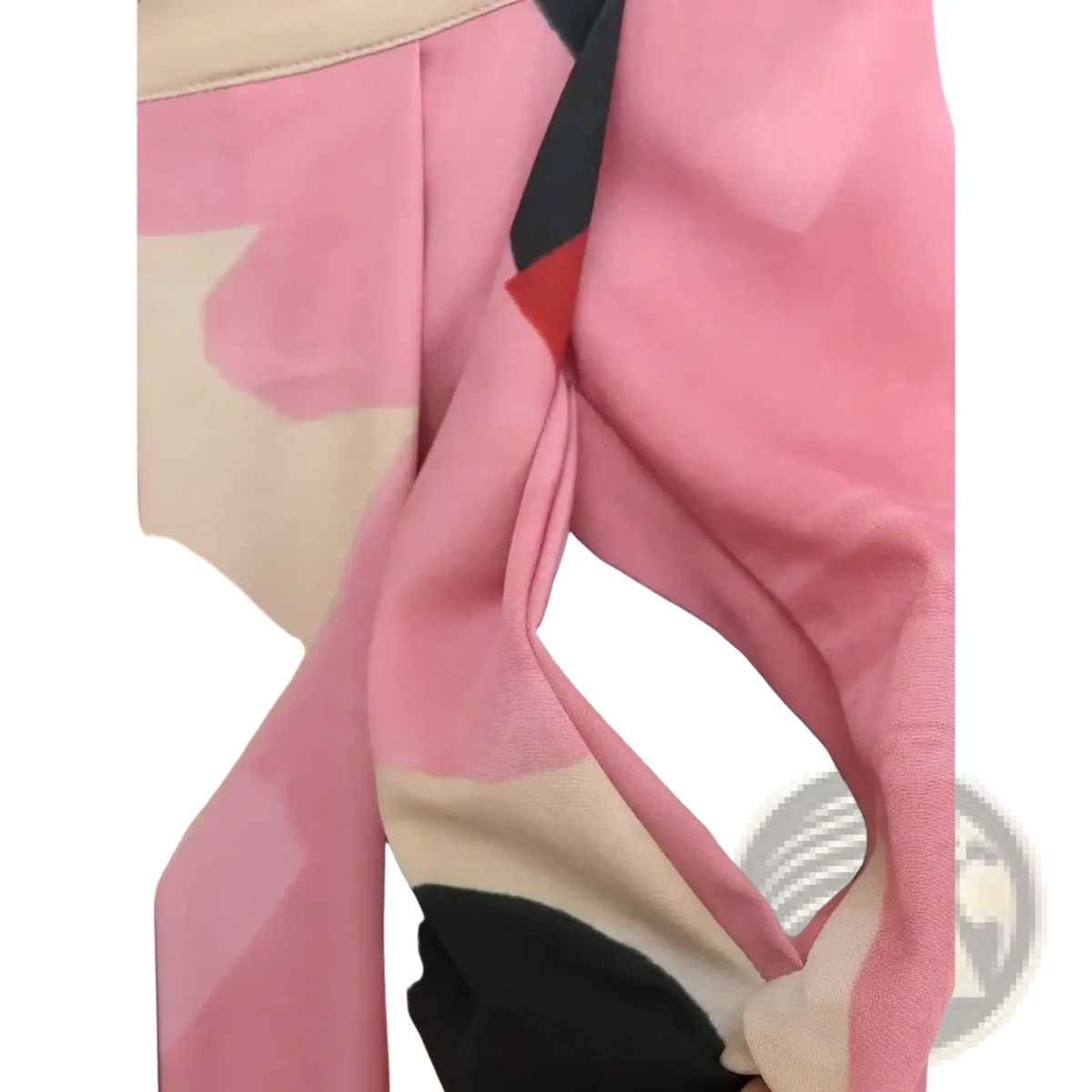 A soft pink beige and black abstract patterned scarf made of lightweight fabric styled with a geometric satin midi skirt