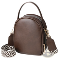 Brown faux leather mini crossbody bag with geometric-patterned adjustable strap and gold-tone hardware