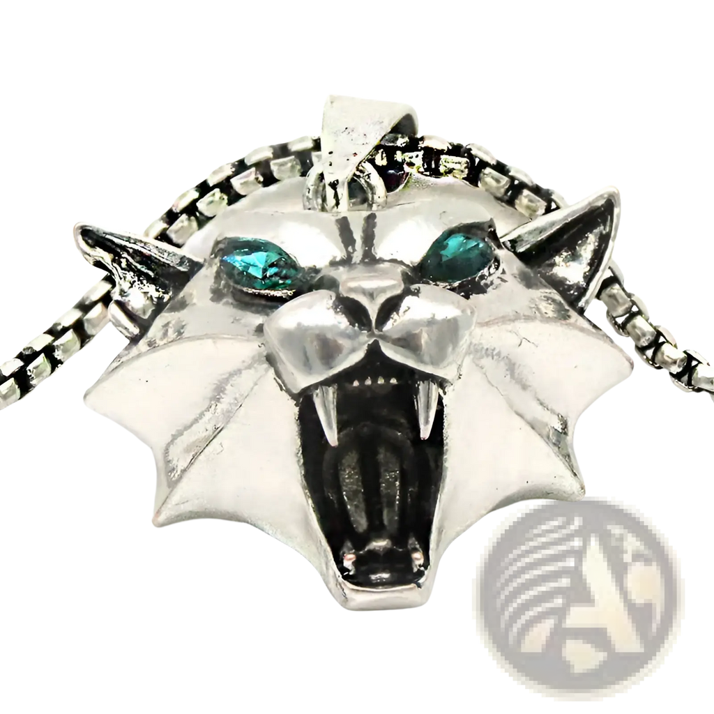 Silver panther pendant chain necklace with teal gemstone eyes and a spiked collar in geometric wild game design