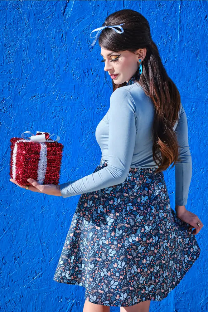 Red glittery gift box with white ribbon and bow complements get cozy blue long sleeve top with cat print collar product display