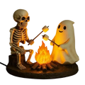 A glowing halloween-themed ghost bonfire night lamp featuring a skeleton ghost roasting marshmallows with warm orange light