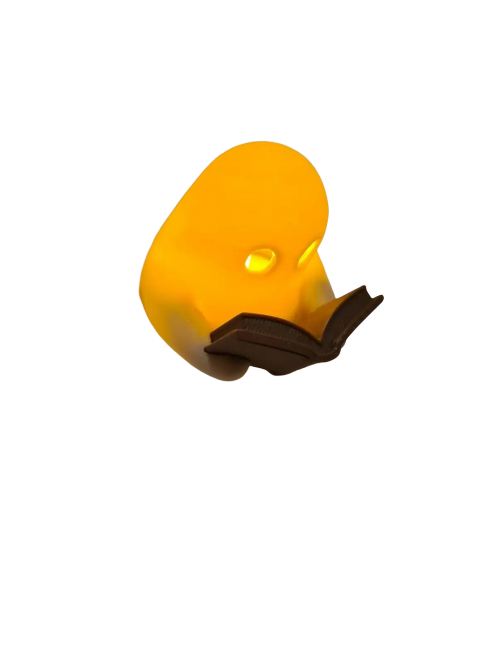 A glowing yellow rubber duck ghost reading book figurine with flickering tealight holding an open book