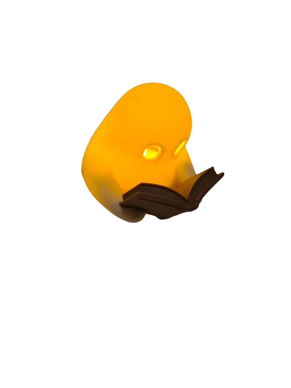 A glowing yellow rubber duck ghost reading book figurine with flickering tealight holding an open book