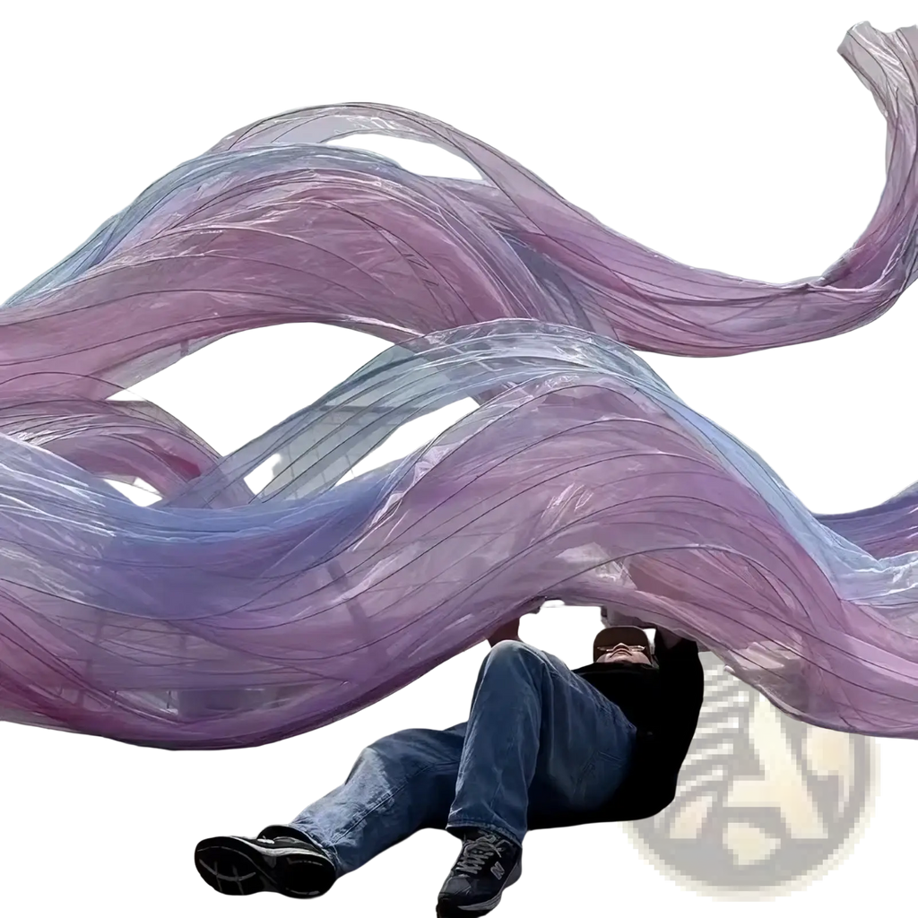 A flowing translucent purple and lavender sheer fabric sculpture with wavy ribbon design for giant gauze flower streamer backdrop decor