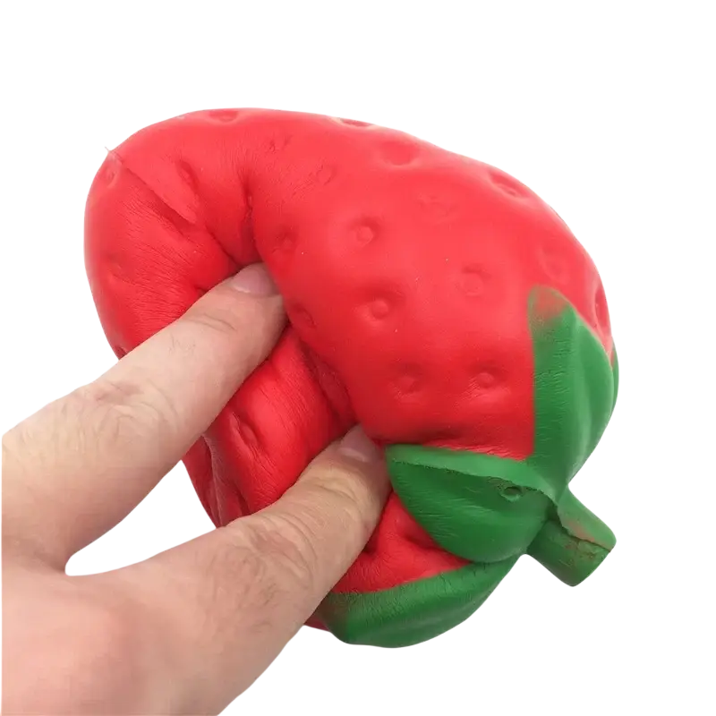 Red strawberry-shaped slow rising squishy stress relief toy made of soft silicone with a green leafy top