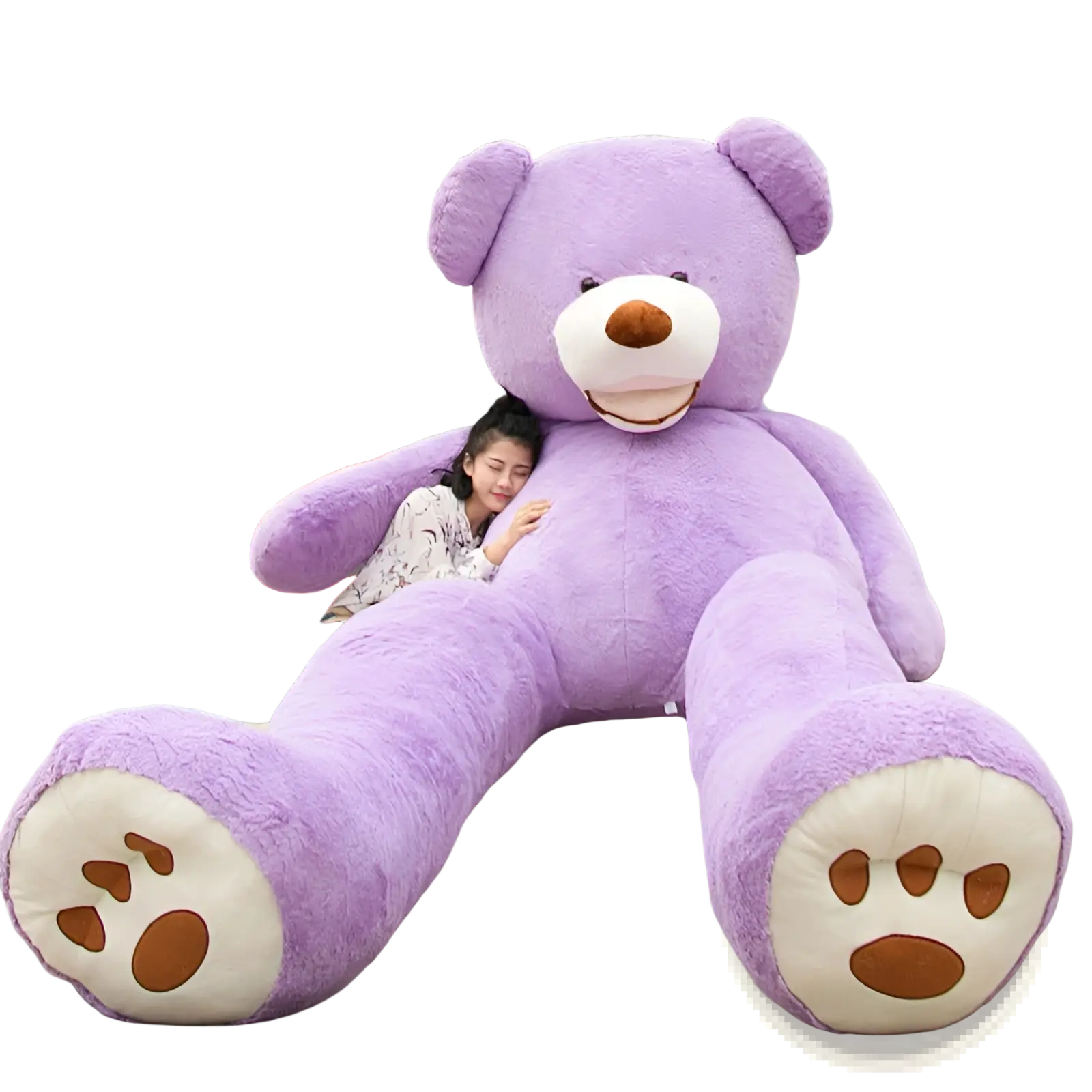 A plush lavender giant teddy bear with white paws and a brown nose sitting on steps made of soft stuffed material